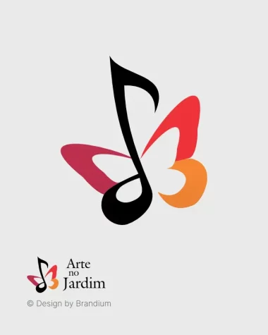 Design da marca Arte No Jardim, representado com borboleta de asas abertas estilizada (simplificada), e, ao centro uma nota musical.